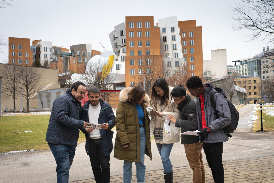 Group of DEDP master's students standing on MIT's campus