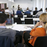 Two people listening to a lecture