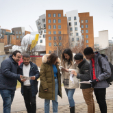 DEDP master's students looking through booklets