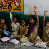 Children with open books raising their hands